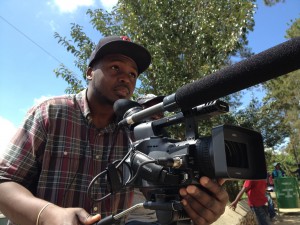 Armand behind the camera in Haiti, filming his documentary about "brain drain." Armand hopes to continue storytelling through filmaking in the future.