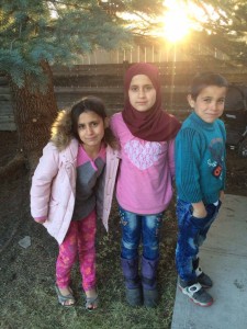 Even though there is a language barrier, Amanda Buessecker's family has become close to their new Syrian neighbors. In Calgary, the mother is relieved as the children play in the neighborhood park without the threat of warfare. (Courtesy of Amanda Buessecker)