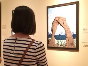 Emily Cameron of American Fork enjoys a painting of the Delicate Arch at the BYU Museum of Art (Jennifer Ball)