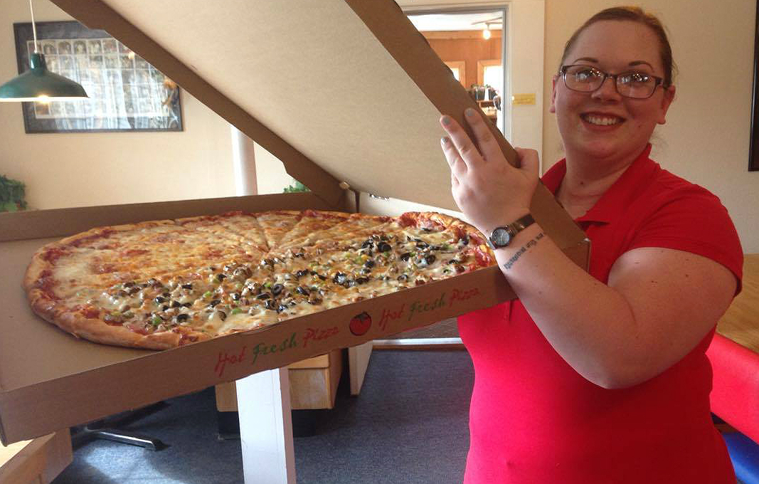 Pizza Co. employee brings out "Old Ephraim" for customers. 