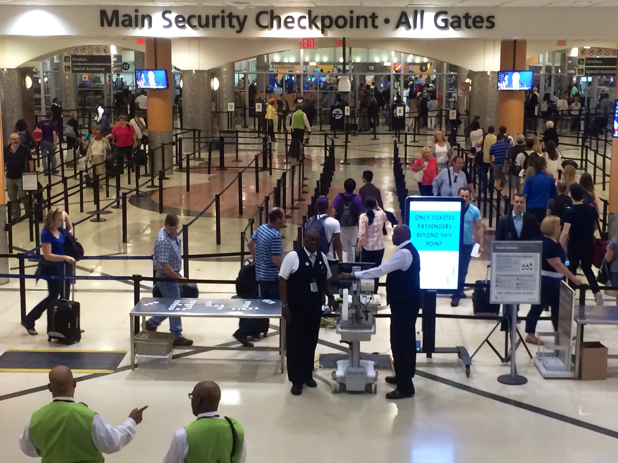 Travelers pass through the main security gate at Hartsfield-Jackson Atlanta International Airport, Friday, May 27, 2016. Memorial Day weekend, the unofficial start of summer vacations for many and a busy travel period, serves as a crucial test for the TSA agency. (AP Photo/Jeff Martin)