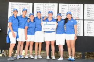 The BYU women's golf team poses in front of the leaderboard. The Cougars qualified for the NCAA Finals over the weekend. (BYU Athletics) 