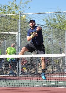 A pickleball player goes for an overhead smash. Pickleball is becoming a popular sport for many. (Wayne Dollard)