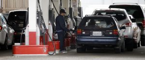 FILE - In this Wednesday, May 6, 2015, file photo, cars line up as an attendant pumps gas at a station in Portland, Ore. On Thursday, June 16, 2016, the Labor Department reports on U.S. consumer prices for April. (AP Photo/Don Ryan, File)