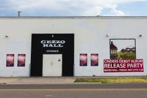 The local concert venue Gezzo Hall paints large murals on the side of their building to promote their concerts and events. (Chase Lewis)