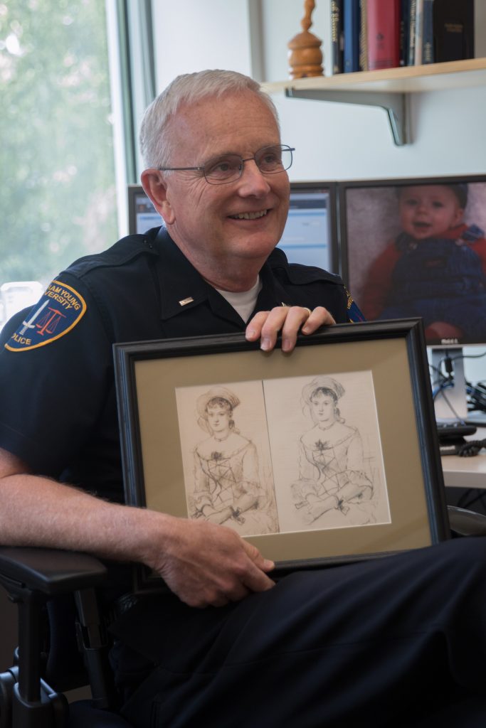Lt. Arnold Lemmon holds his copy of the forged and original Winslow Homer sketch, "The Shepherdess." Lemmon worked on retrieving over 900 missing pieces of BYU-owned art during his career. (Natalie Stoker)