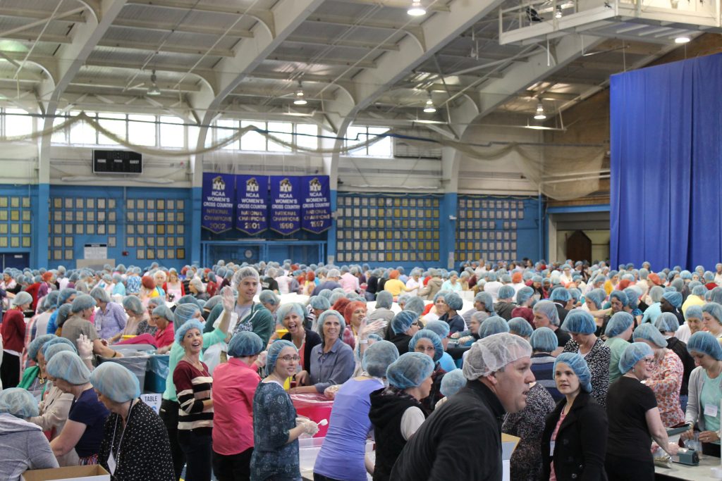 After: Women's Conference participants help assemble meal kits 