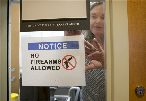 University of Texas at Austin Anthropology professor Pauline Strong posts a sign prohibiting guns at her office on the first day of the new campus-carry law Monday, Aug. 1, 2016. The law pushed by Gov. Greg Abbott and the Republican legislative majority will make Texas one of a handful of states that guarantee the right to carry concealed handguns on campus. (Jay Jenner/Austin American-Statesmanvia AP)