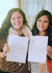 From left: Francesca Montagnoli Mullins and Lucia Mullins hold up their mission calls to the same mission. Francesca finished her mission in Milan, Italy, a month before Lucia received her call to the same mission. (Lucia Montagnoli)