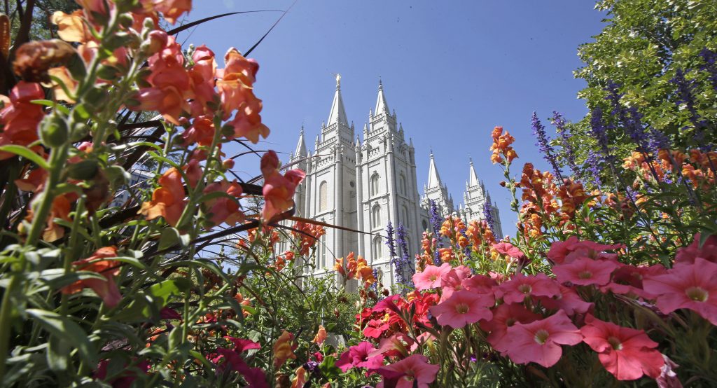 FILE - This Aug. 4, 2015,file photo, flowers bloom in front of the Salt Lake Temple, at Temple Square, in Salt Lake City. On Monday, Sept. 5, 2016, Mormon church officials said they are decreasing the number of missionaries being sent to Russia as part of a series of adjustments because of a new Russian anti-terrorism law. (AP Photo/Rick Bowmer, File)