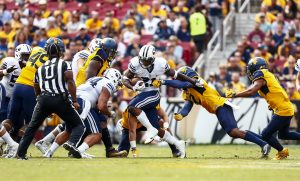 BYU running back Jamaal Williams carries the ball against West Virginia. Williams set BYU's single game rushing record against Toledo. (BYU Photo)