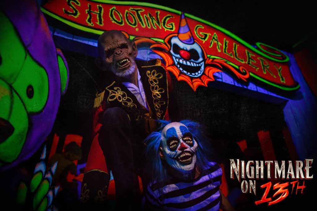 Clowns scare people in the shooting gallery at Nightmare on 13th. (Nightmare on 13th)