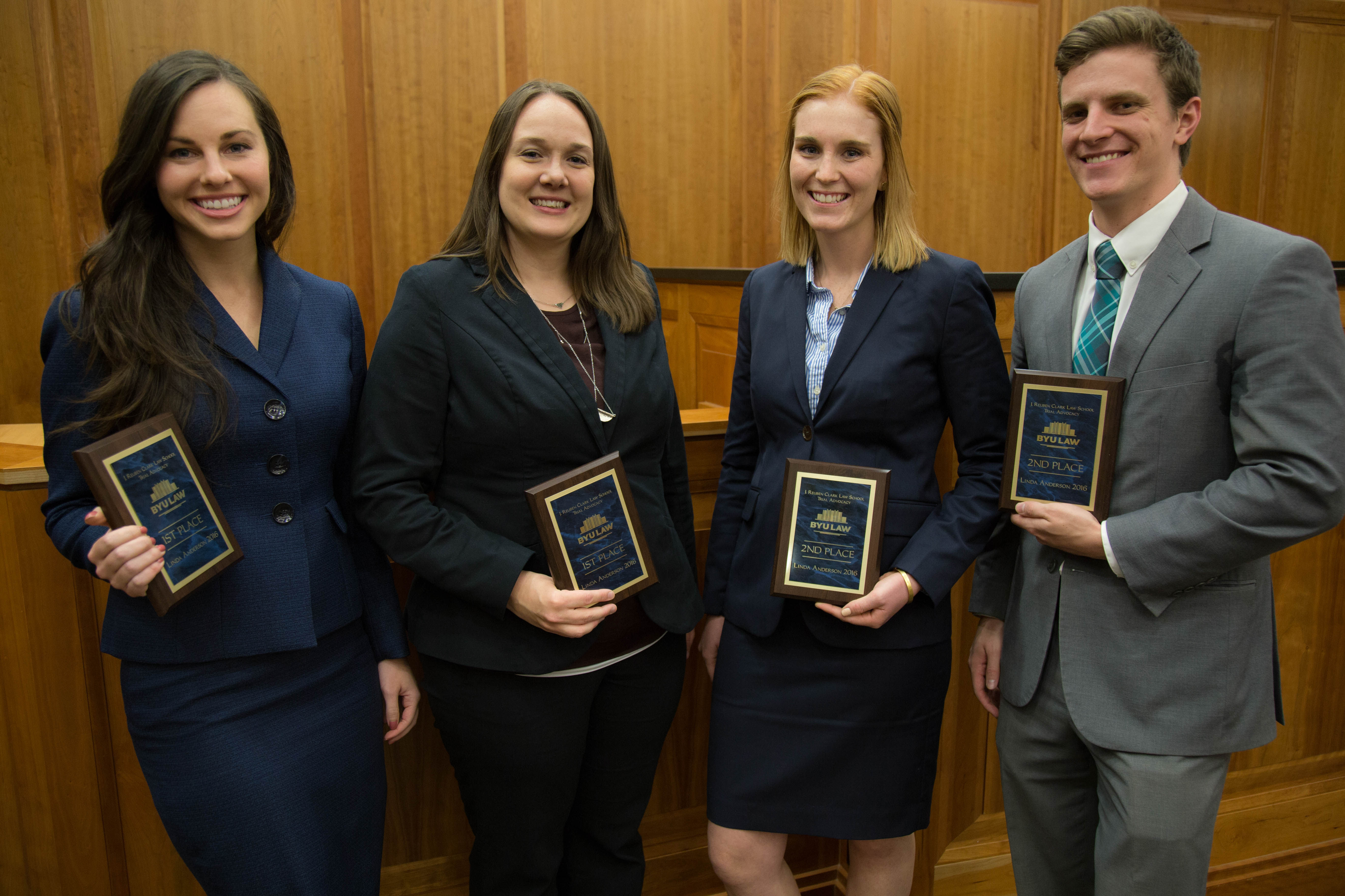 Krista-Lee Crook and Samantha Scott hold their first place plaques. They stand next to their competition, Bronwen Evans and Mike Snell. (BYU Law School) 