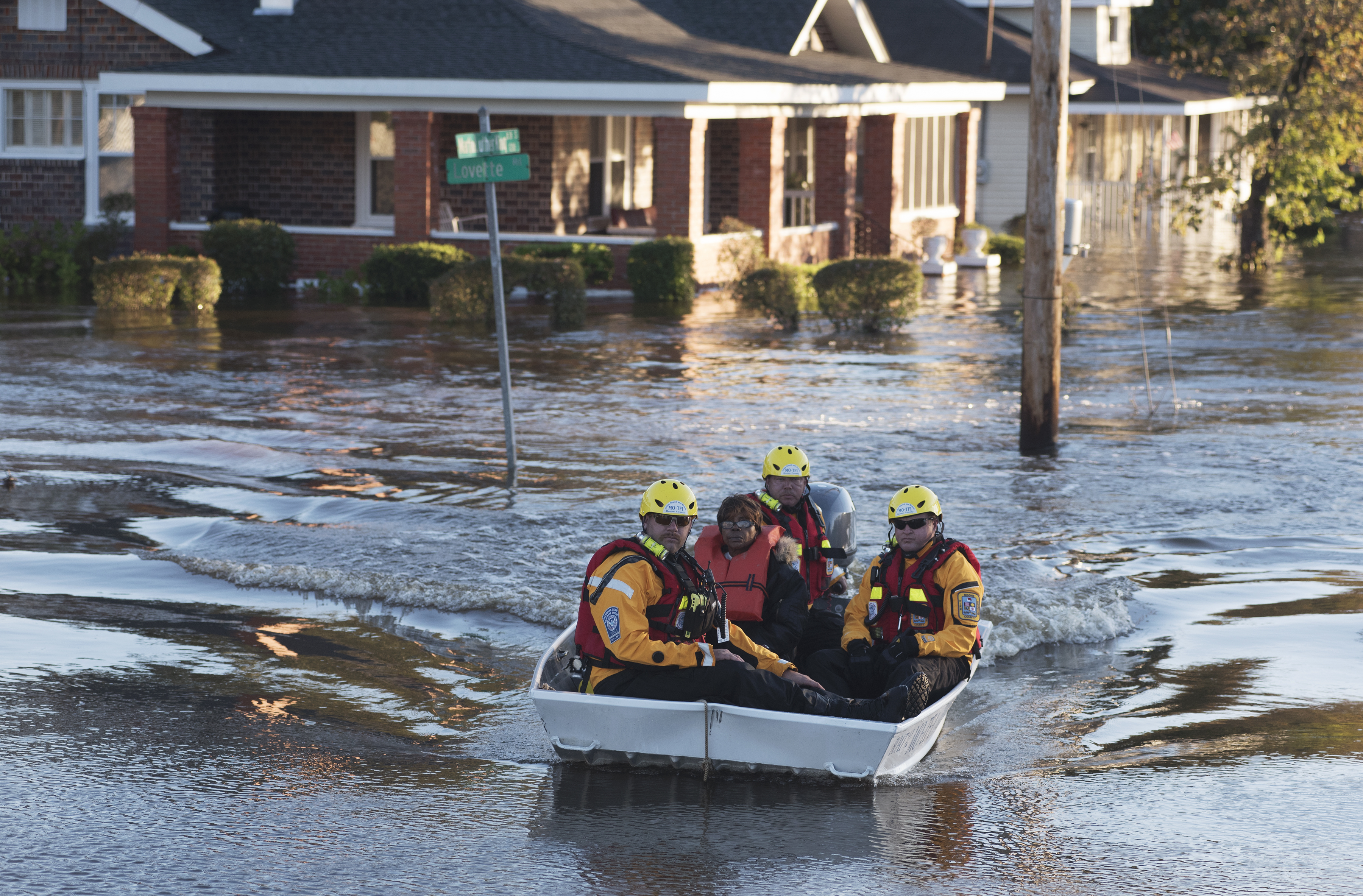 A swift water rescue team transports a resident of to safety on a street covered with floodwaters caused by rain from Hurricane Matthew in Lumberton, N.C., Monday, Oct. 10, 2016. (AP Photo/Mike Spencer)