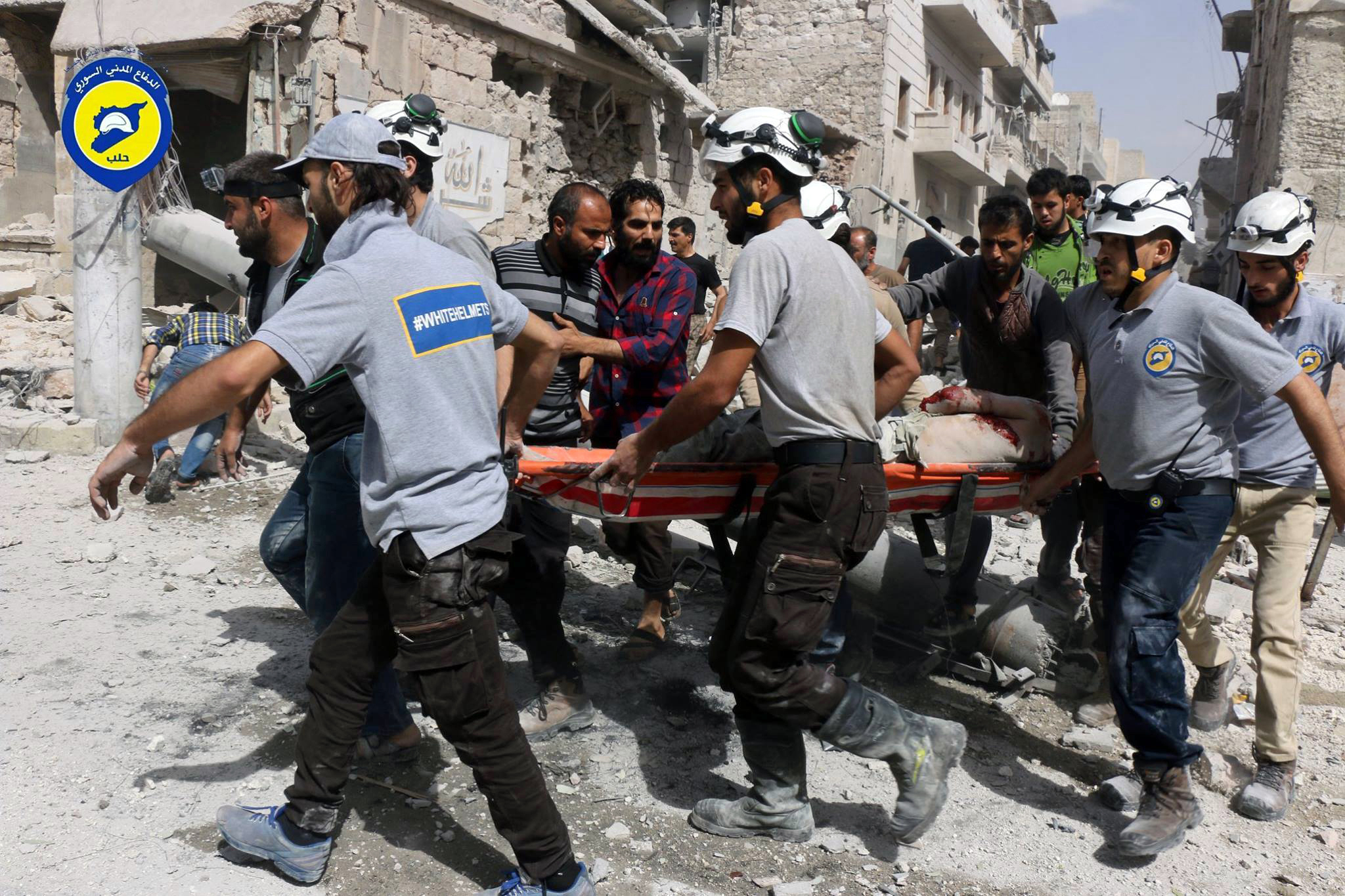 FILE - In this Wednesday, Sept. 21, 2016, file photo, provided by the Syrian Civil Defense White Helmets, rescue workers work the site of airstrikes in the al-Sakhour neighborhood of the rebel-held part of eastern Aleppo, Syria. Violence in Aleppo has surged in recent days as a U.S.-Russia-brokered cease-fire collapsed after one week. The Syrian government and its ally Russia have resumed intense airstrikes and Syrian military officials have spoken of a looming ground offensive against rebel-held districts. (Syrian Civil Defense White Helmets via AP)