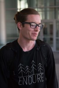 Political science major James Hodgson wore black as a sign of mourning, but chose this shirt specifically "to continue to promote social justice despite elections." (Ryan Turner)