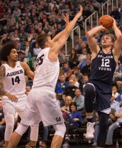 Eric Mika shoots over a Utah State defender. Mika 