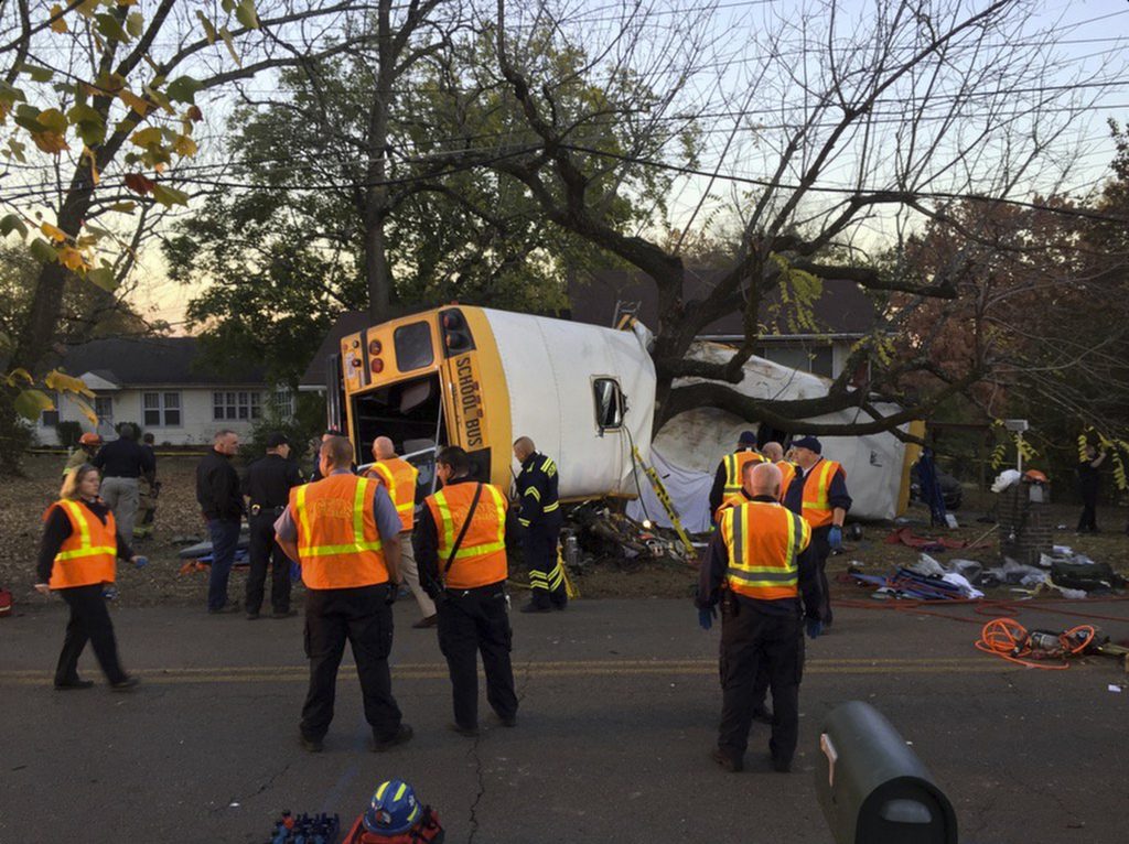 In this photo provided by the Chattanooga Fire Department via Chattanooga Times Free Press, Chattanooga Fire Department personnel work the scene of a fatal elementary school bus crash in Chattanooga, Tenn., Monday, Nov. 21, 2016. In a news conference Monday, Assistant Chief Tracy Arnold said there were multiple fatalities in the crash. (Bruce Garner/Chattanooga Fire Department via Chattanooga Times Free Press via AP)