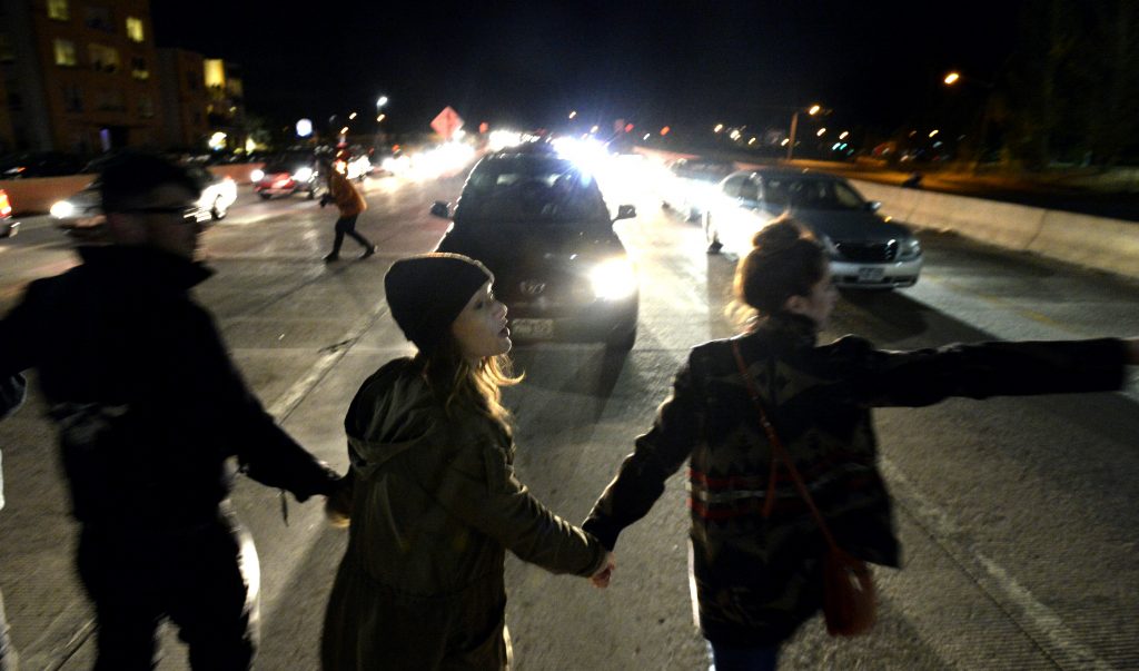 In this Thursday, Nov. 10, 2016 photo, marchers block traffic on highway US 36 just outside Boulder, Colo., during a protest in opposition of Donald Trump's presidential election victory. (Paul Aiken/Daily Camera via AP)