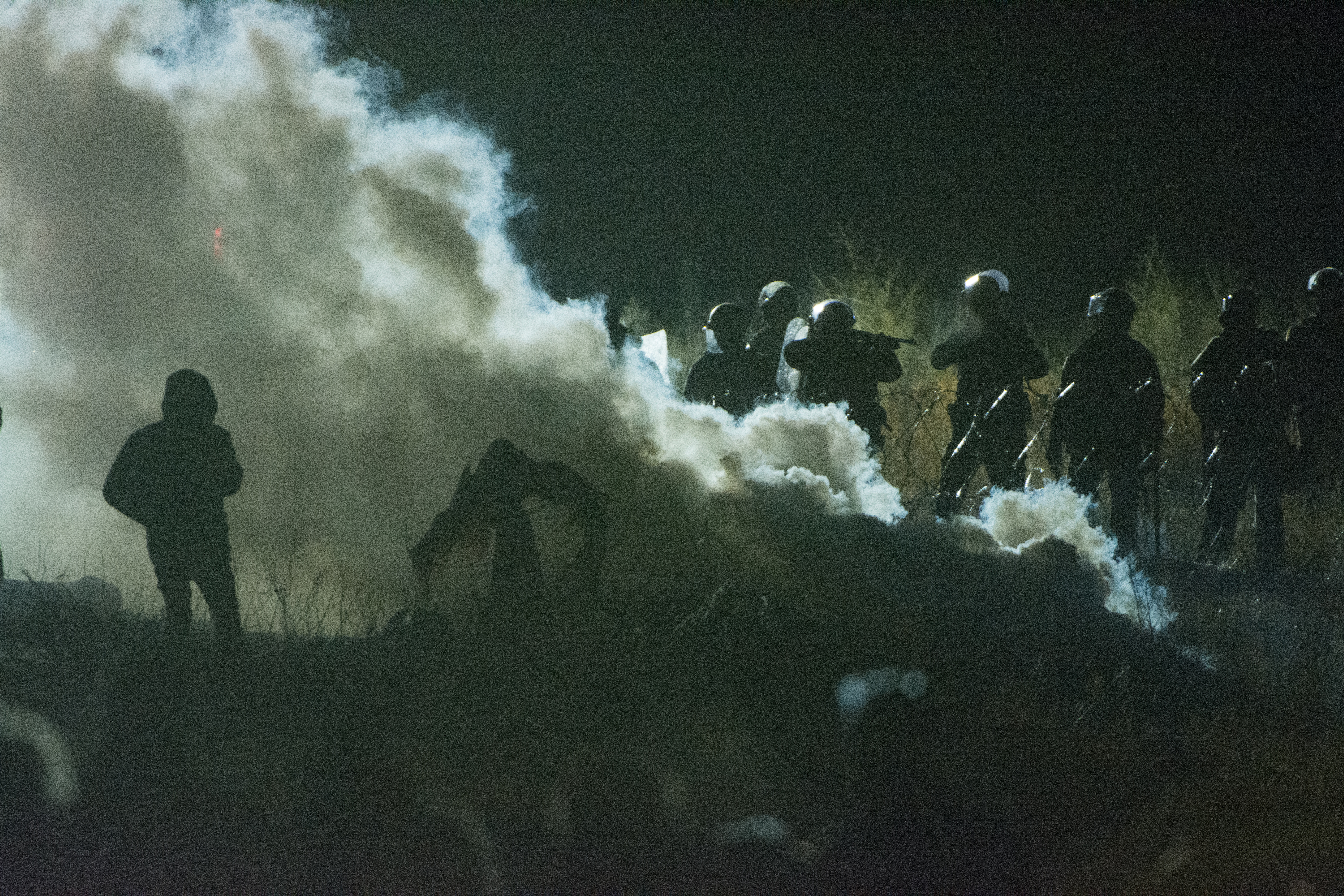 Police officers tear gas peaceful protesters at Standing Rock. (Ryan Turner)