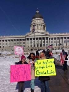 (BYU sophomore Erica Smith, social media administrator for Pro-Life Utah and Mrs. World Ambassador for Children Heather Richey, and UVU graduate Kimberly Motteshard stand with pro-life signs in front of the Utah State Capitol Building.) (Katelyn Kenedy)