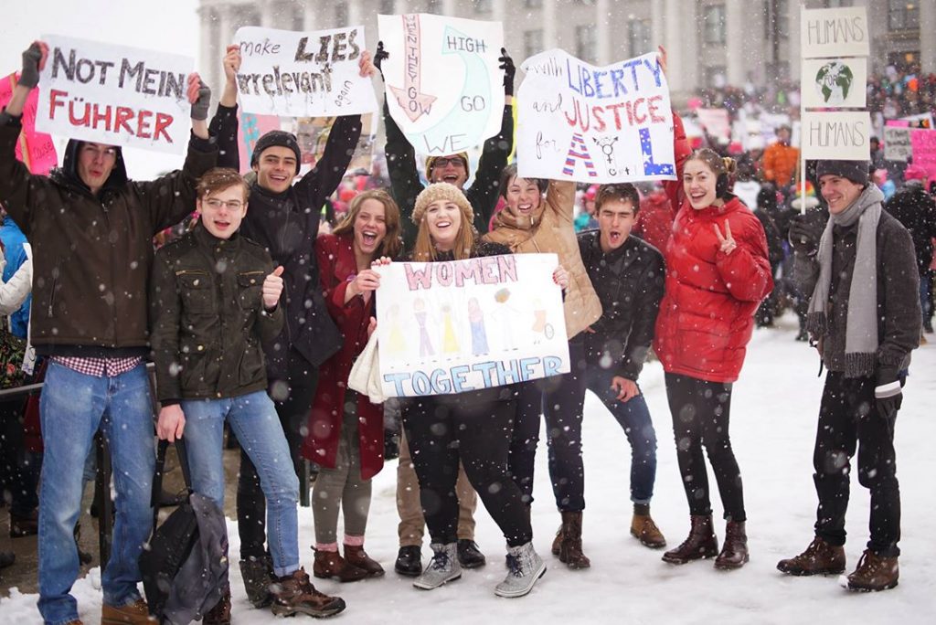 Sarah Christensen (far right in red coat) and her fellow BYU students march together at the Utah Capitol,