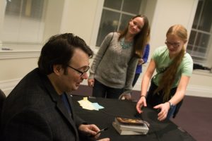 Brandon Sanderson signs books for fans. Sanderson spent more than three hours signing books after his speech. (Ryan Turner)