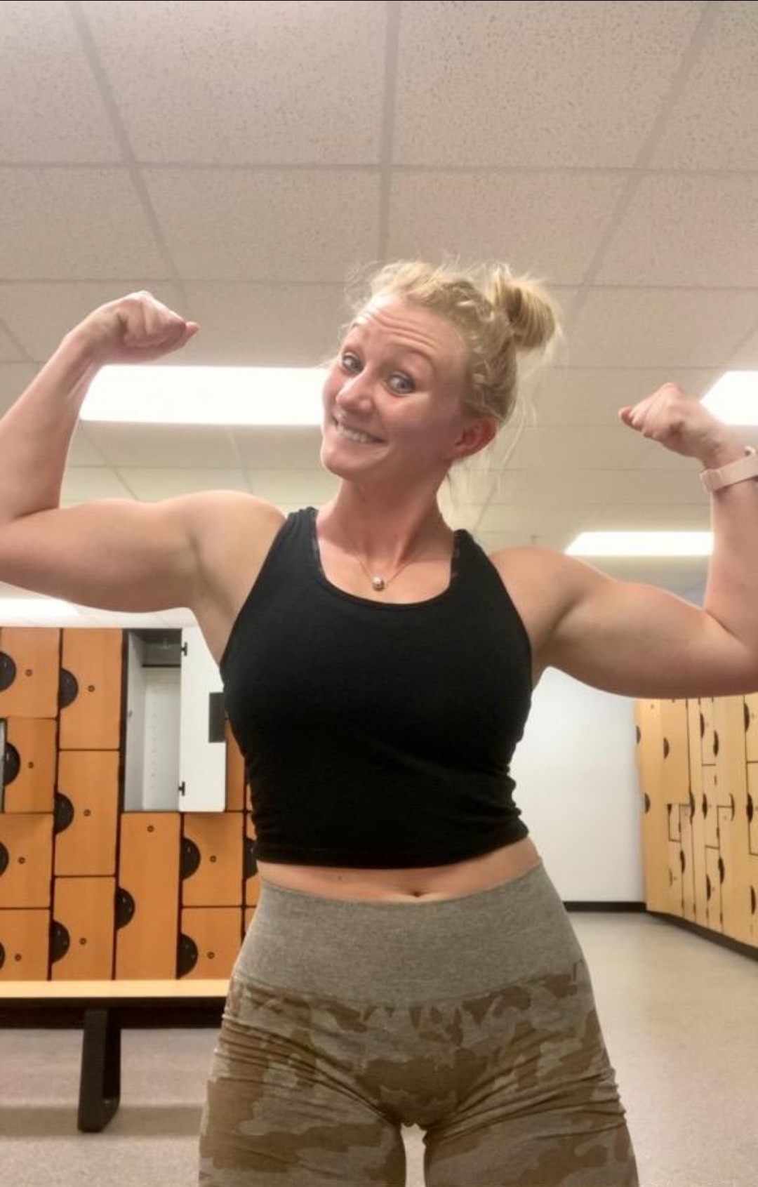 Smiling Female Athlete Flexing Muscle, Empowered and Strong