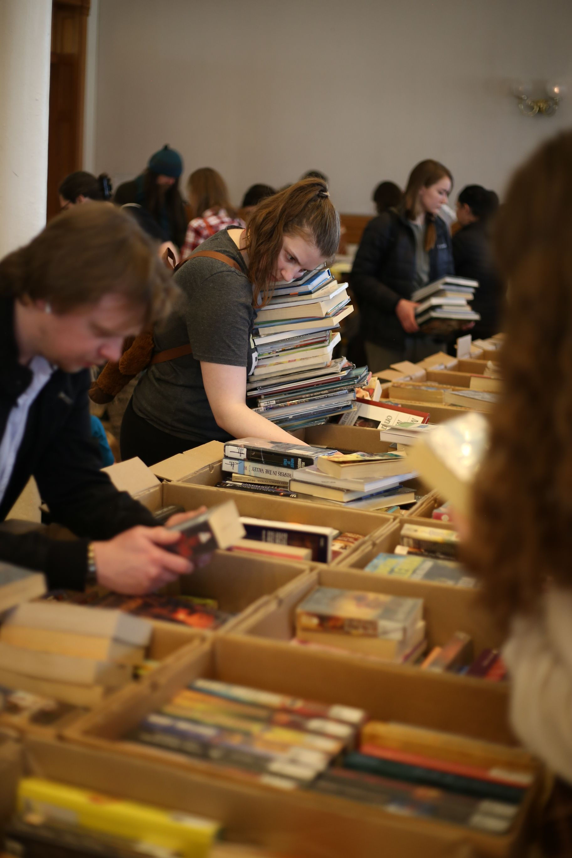 Attendees grabbed as many books as they could carry at the Provo Library used book sale. (McKenna Jensen)