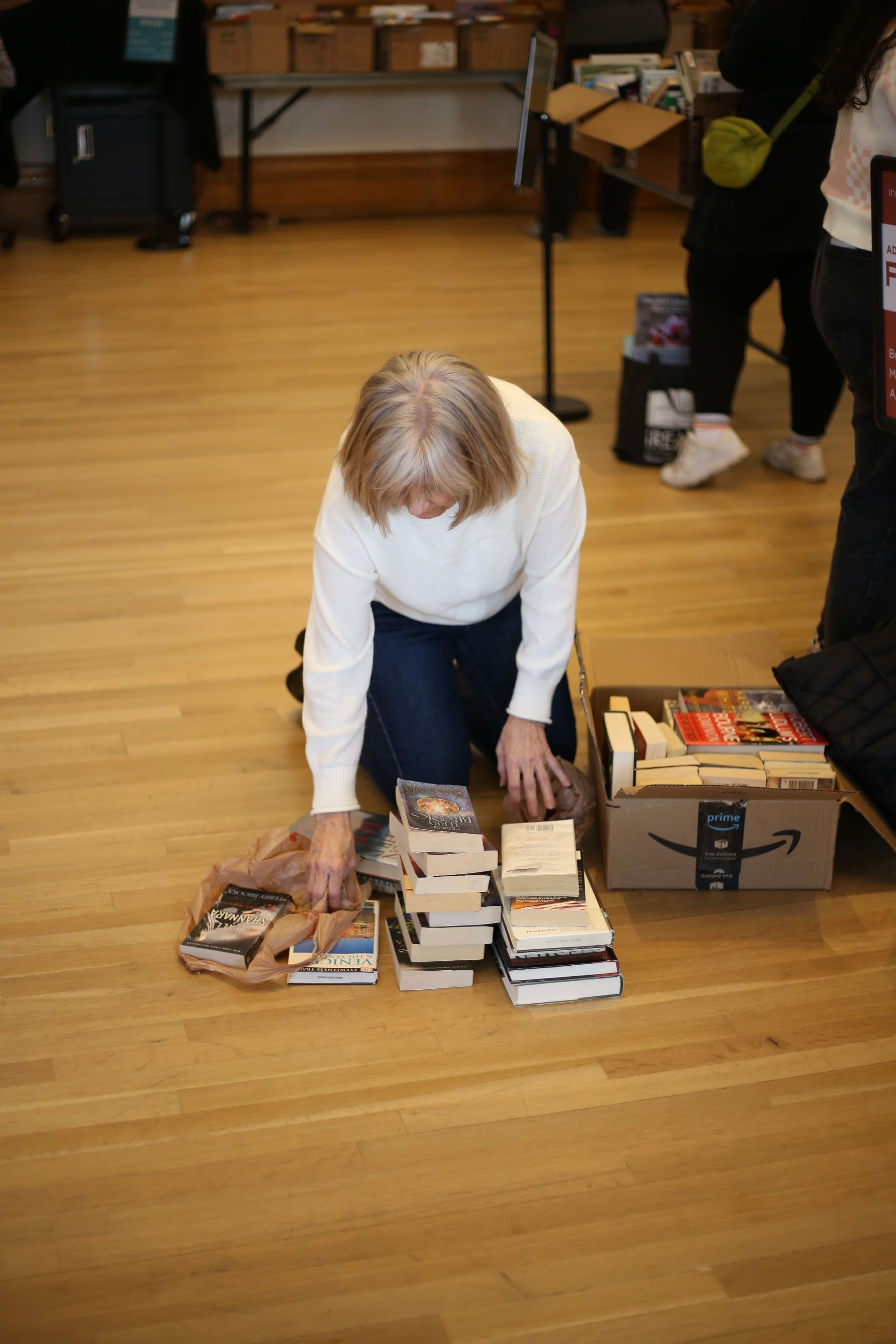 Individuals load boxes full of books at the Provo Library used book sale. (McKenna Jensen)